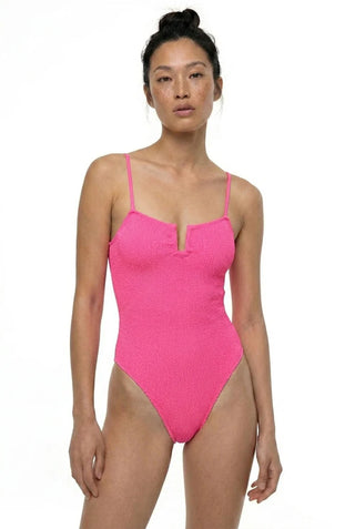 Model trögt ein Badeanzug der griechischen Marke SORBET ISLAND in der coolen neon Farbe Neon Strawberry.